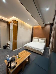 a hotel room with a bed and a table at Comfort Hotel in Osh