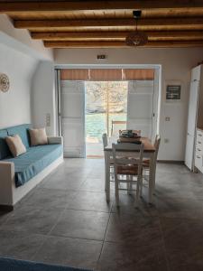 a living room with a table and a couch at Troulou beach house in Kimolos