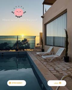 a swimming pool with two lounge chairs next to a house at Luxury Mountain Chalet with Private Pool Lionden Jerash in Jerash +7 photos