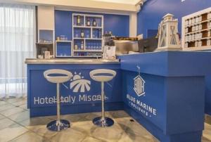 a blue counter with bar stools in a store at Hotel ITALY in Misano Adriatico