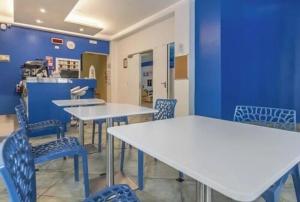 a room with tables and chairs and a blue wall at Hotel ITALY in Misano Adriatico