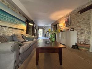 a living room with a couch and a coffee table at La Maison aux Puits in Cordes-sur-Ciel