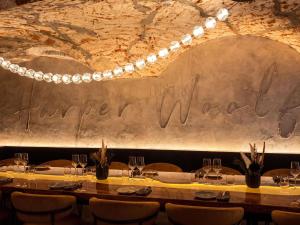 a table in a restaurant with a sign on the wall at Pullman Riga Old Town - Renovated 2025 in Riga