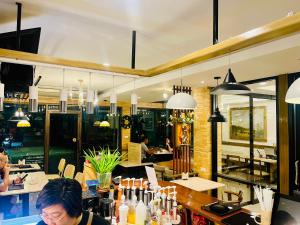 a woman sitting at a bar in a restaurant at Silpasala StayZ in Sathani Ban Hua Mak +33 photos