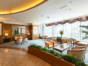 a lobby of a hotel with chairs and tables at Tsubamesanjo Washington Hotel in Sanjo