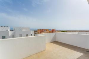 a view from the balcony of a house with white walls at Salitre y lava in Corralejo