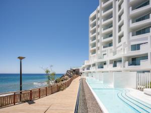 a view of a building with the ocean in the background at The Salmar - Adults Only in San Miguel de Abona