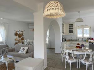 a living room and kitchen with a table and a couch at Irene's House in Aliki in Aliki
