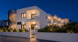 a white building at night with a building at Domenica Apartments in Rethymno