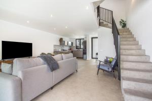 a living room with a couch and a staircase at Salitre y lava in Corralejo