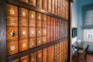 a bunch of books on a wall in a room at Beit Toureef - SARAYA HALA 'PALATIAL' in Beirut
