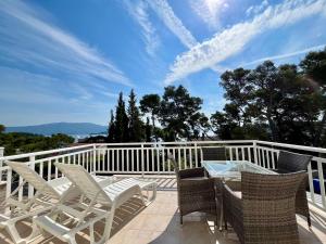 a patio with chairs and a table on a balcony at Villa Joković in Lumbarda