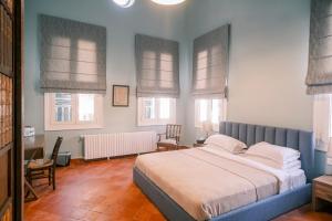 a bedroom with a large bed and windows at Beit Toureef - SARAYA HALA 'PALATIAL' in Beirut +73 photos
