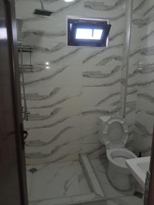 a bathroom with a toilet and a window in it at ilios in Kobuleti +54 photos