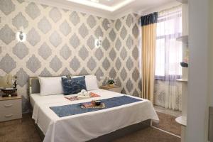 a bedroom with a bed with a tray on it at OSMAN villa in Samarkand