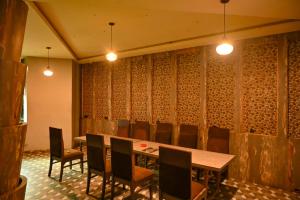 a dining room with a table and chairs and lights at Hotel Dhola Maru in Kota