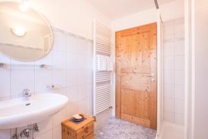 a bathroom with a sink and a mirror at Bnb Lettnerhof Terrace Family Suite in Monguelfo +15 photos