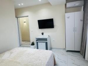a bedroom with a bed and a tv on the wall at Bar Hotel Mokador in Shkodër +95 photos