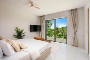 a bedroom with a large bed and a large window at Modern Jungle Pool Villa in Mae Nam