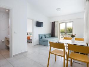 a living room with a table and a couch at Lotus Hotel Apartments in Kato Daratso