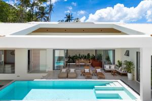 two views of a house with a swimming pool at Modern Jungle Pool Villa in Mae Nam