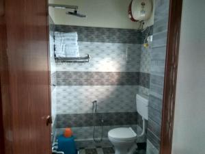 a bathroom with a toilet and a shower at Elroy Homestay in Kalpetta +15 photos