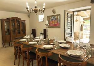a dining room with a wooden table and chairs at Villa Olmeto in Lupoglav