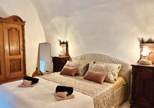 a bedroom with a bed with two hats on it at Villa Olmeto in Lupoglav +30 photos