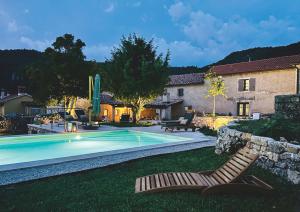 a yard with a swimming pool and a house at Villa Olmeto in Lupoglav