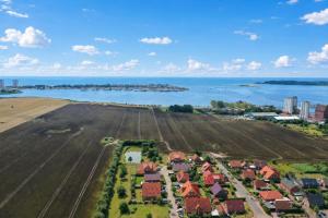an aerial view of a town with a field and the ocean at 10 Ferienwohnung Anders Fewo 1 in Burg auf Fehmarn +4 photos