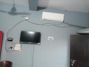 a television on the wall of a room at Subhalaxmi Hotel and Lodge in Bahāsi