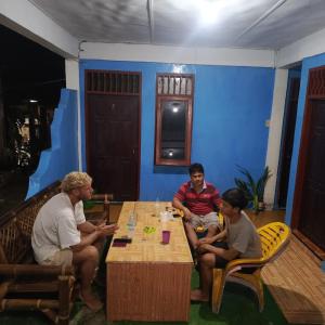 a group of people sitting around a table in a room at Ustin Nagoya Bukit Lawang Orangutan Trekking & transport You can only stay at the hotel if you book your trekking with us in Bukit Lawang