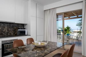 a kitchen and dining room with a table and chairs at The 12th City Hotel in Rhodes Town +63 photos