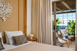 a bedroom with a bed and a sliding glass door at The 12th City Hotel in Rhodes Town