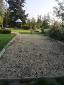 a park with a bench and a gazebo at Lodge18 in Châteaumeillant +1 photo