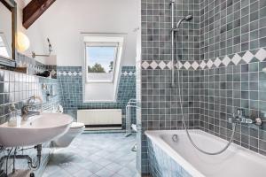 a bathroom with a tub and a toilet and a sink at Schwalbennest in Trebel +26 photos