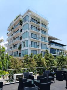 a large white building with chairs in front of it at Water Park Suites in Nugegoda