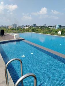 a swimming pool on the roof of a building at Water Park Suites in Nugegoda