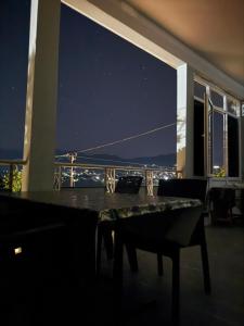 a room with a table and a view of the ocean at Tsikhisdziri Hotel in Ts'ikhisdziri