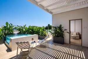 a patio with a swimming pool and a table and chairs at The 12th City Hotel in Rhodes Town