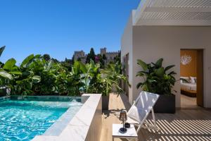 a balcony with a swimming pool and a house at The 12th City Hotel in Rhodes Town