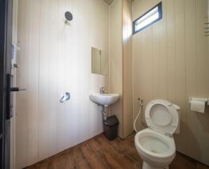 a bathroom with a toilet and a sink at Beji Bedugul Glamping in Bedugul