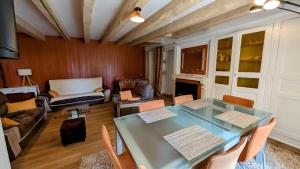 a living room with a table and a couch at Villetelle in Cheissoux