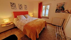 a bedroom with a bed and a window at Villetelle in Cheissoux