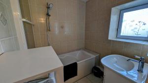 a bathroom with a sink and a bath tub at Villetelle in Cheissoux +21 photos