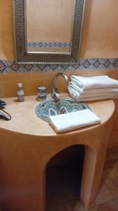 a sink in a bathroom with a mirror at Riad chrifa in Tangier