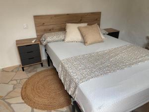 a bedroom with a large bed and a night stand at Campus el abuelo in Denia +34 photos