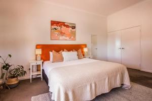 a bedroom with a large bed with a white bedspread at Lana Unit 31 Studio Apartment - Central Base for South West Adventures in Margaret River Town