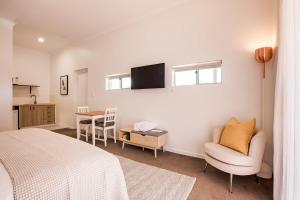 a bedroom with a bed and a chair and a table at Lana Unit 31 Studio Apartment - Central Base for South West Adventures in Margaret River Town