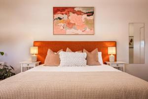 a bedroom with a large bed with two lamps at Lana Unit 31 Studio Apartment - Central Base for South West Adventures in Margaret River Town